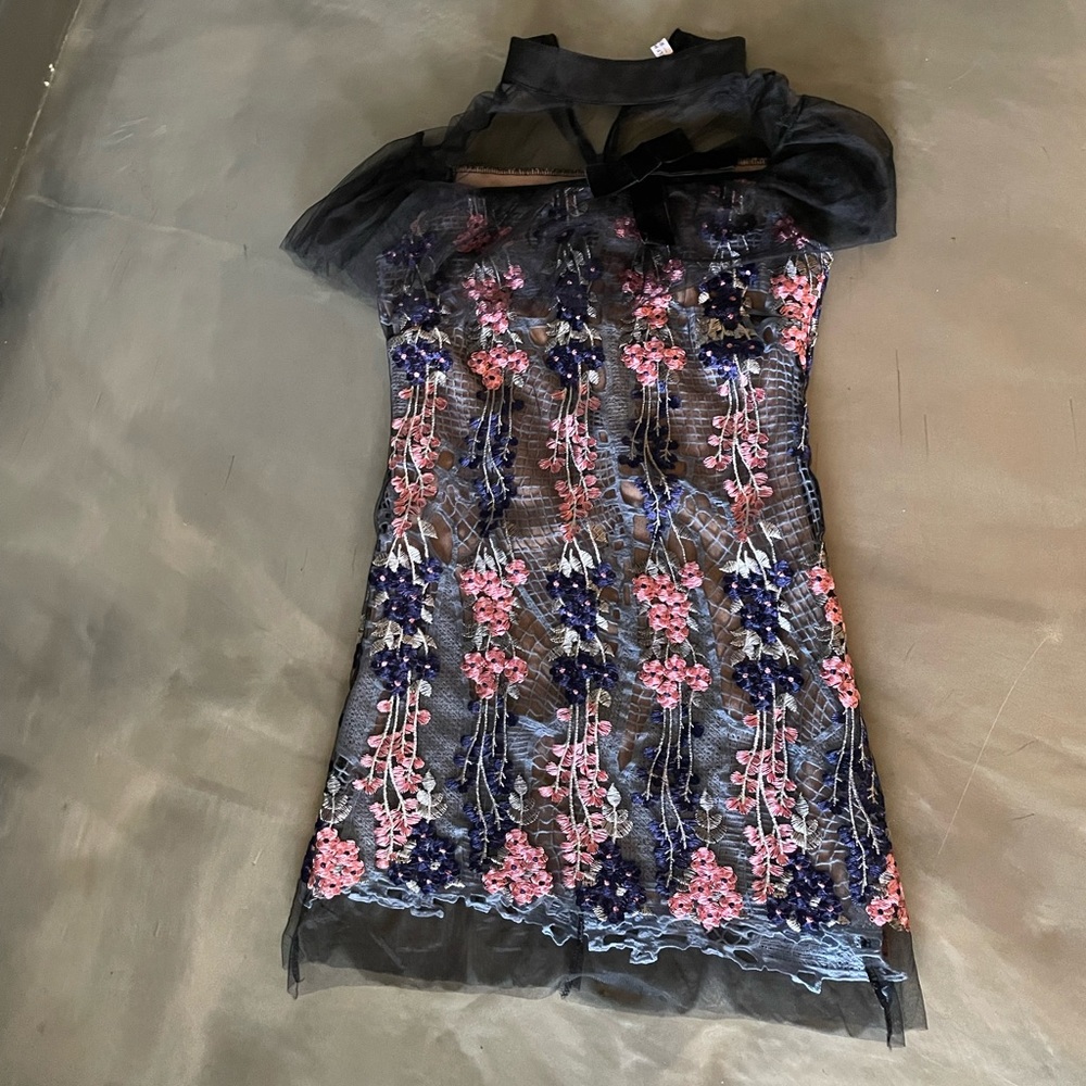 Its a beautiful mini dress. Very feminine and sexy. Never worn.